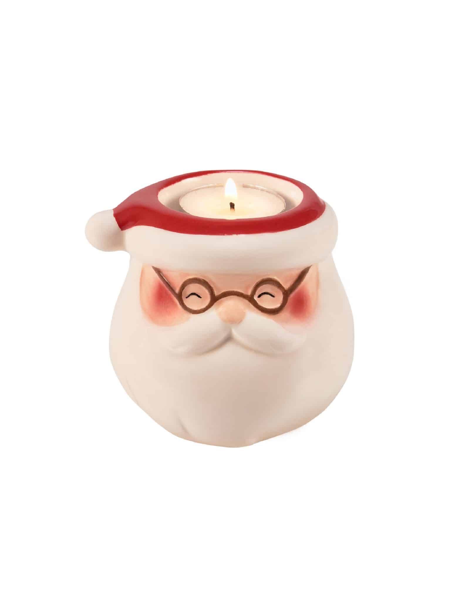 Ceramic tealight holder shaped like Santa’s face with glasses and red hat.