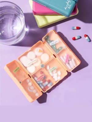 Open Pill & Vitamin Case showing seven compartments filled with vitamins and pills.