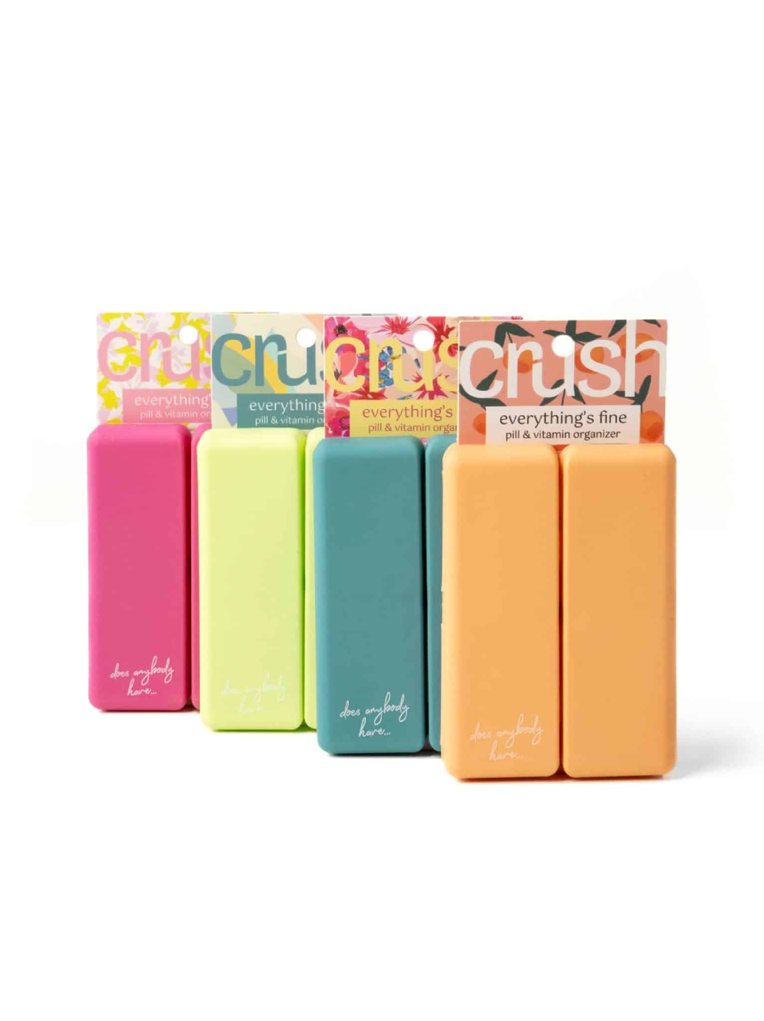 Four colorful Pill & Vitamin Cases standing upright in magenta, lime, teal, and peach.