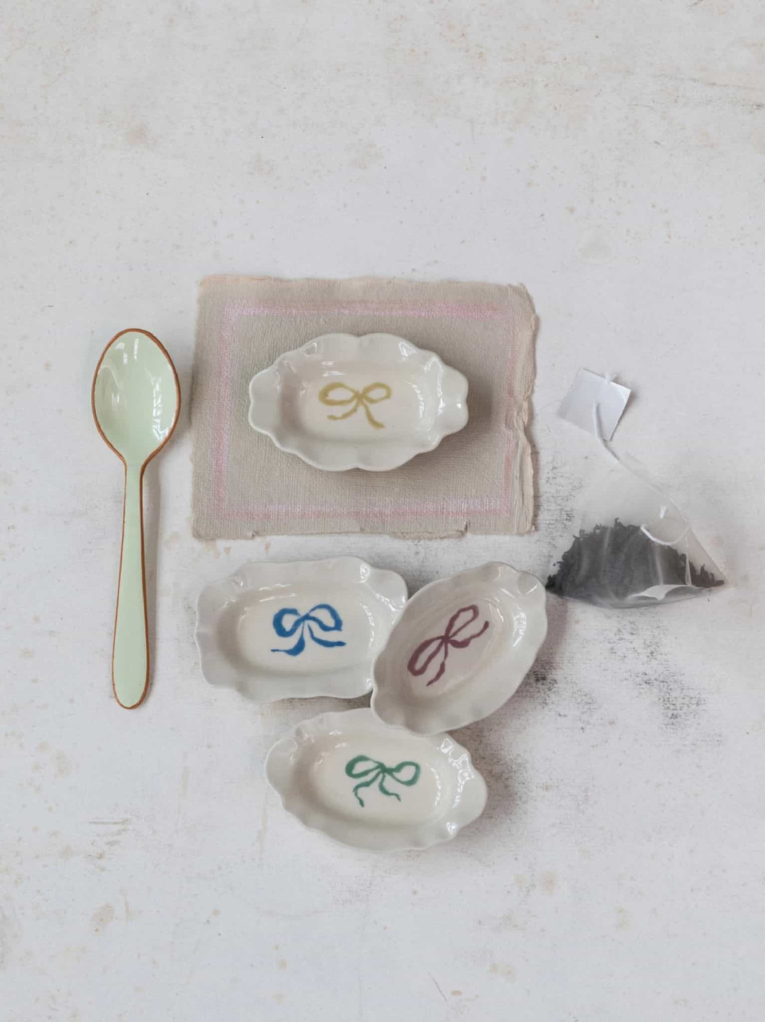 be-made-hays-ks-bow-scalloped-trinket-dish-flatlay Bow Scalloped Trinket Dish in a styled flatlay with assorted colors.