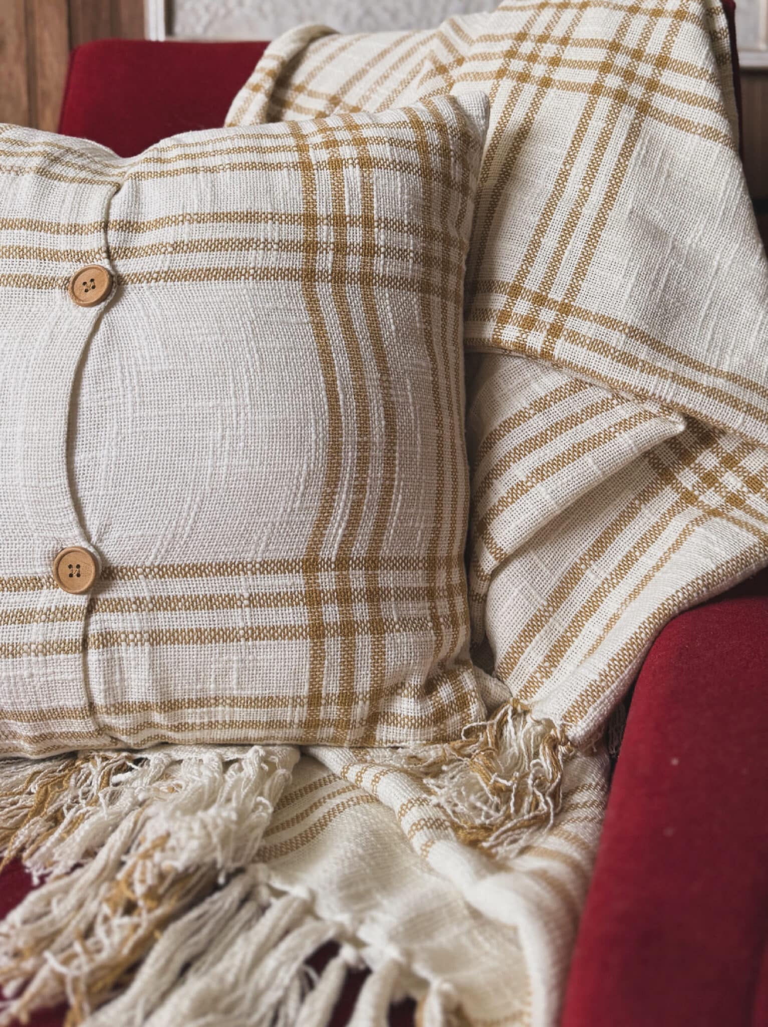be-made-hays-ks-wheat pillow-03-01 The Plaid Woven Wheat Throw Pillow adds soft texture and simple charm to any room. Its warm cream base and wheat-colored plaid lines create a cozy, classic look. The reversible cover and wooden button-style closures give it a sweet, homespun touch. Style it on a sofa, bed, or accent chair. It also pairs perfectly with our matching Plaid Woven Wheat Throw Blanket. The look is easy, neutral, and made for farmhouse, cottage, or modern natural decor. This pillow is comfortable, versatile, and beautiful for year-round use. Material: 100% cotton cover with polyester fill Details: Removable cover for easy cleaning Dimensions: 18″ x 18″