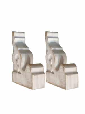 Set of two ornate ivory corbel bookends with carved scrollwork and a distressed finish, shown standing upright against a white background.