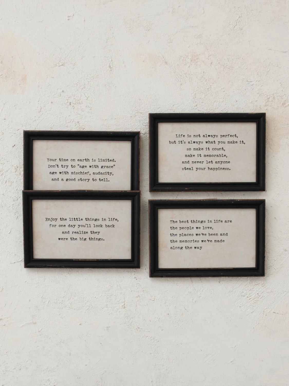 be-made-hays-ks-wood-framed-quote-sign-wall-decor Set of four black wood framed quote signs with typewriter-style text, each featuring an inspirational saying on a neutral background.