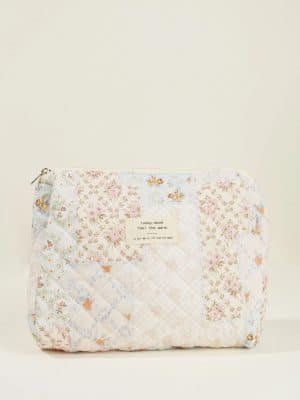 Quilted Floral Makeup Bag – Medium with pastel patchwork design and zipper closure, shown standing against a neutral background.