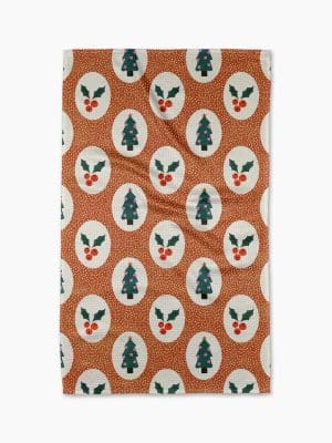 Vintage Christmas Geometry towel with repeating holly berry and Christmas tree pattern on a festive brown background.