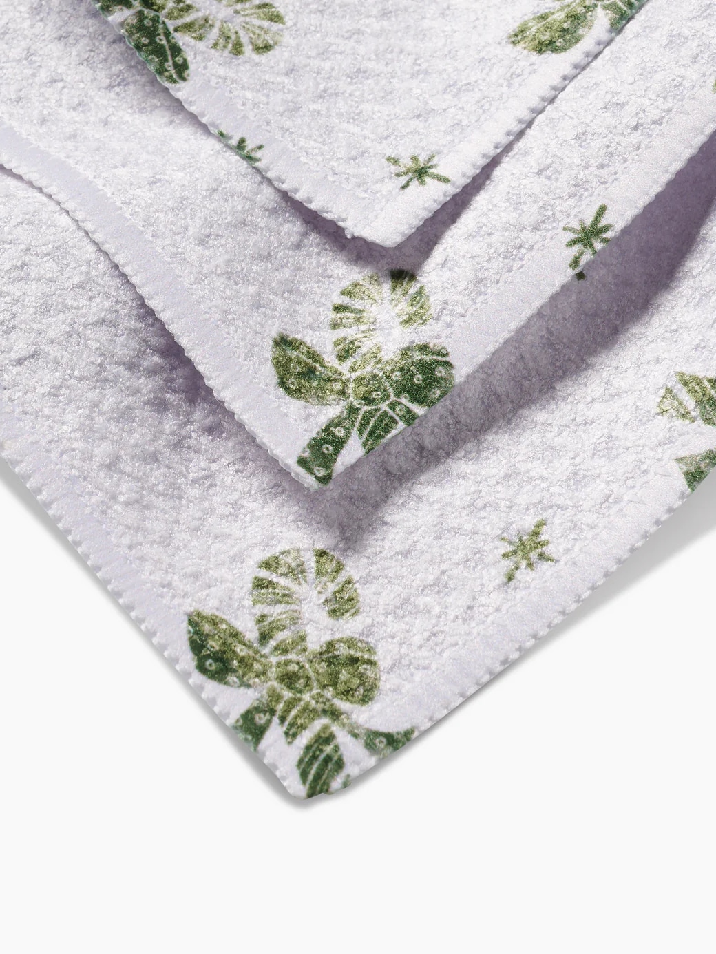 Holiday dishcloth set featuring green candy cane bows on crisp white by Geometry.