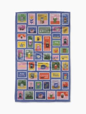 Geometry kitchen towel with colorful postage stamp pattern featuring coffee cups, lattes, French presses, and “But First Coffee” designs.