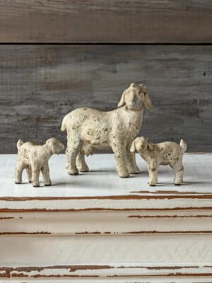 Rustic Goat Family Figurines set of three in aged white resin styled on a distressed wood surface, featuring a large goat with two smaller goats for farmhouse and cottage decor.