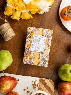 Harvest Gold scented sachet packet placed on a wooden table with apples and fall decor.