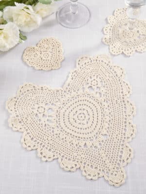 Heart Cream Lace Doily in ecru cotton crochet styled on a tabletop, highlighting its intricate pattern and vintage-inspired texture.