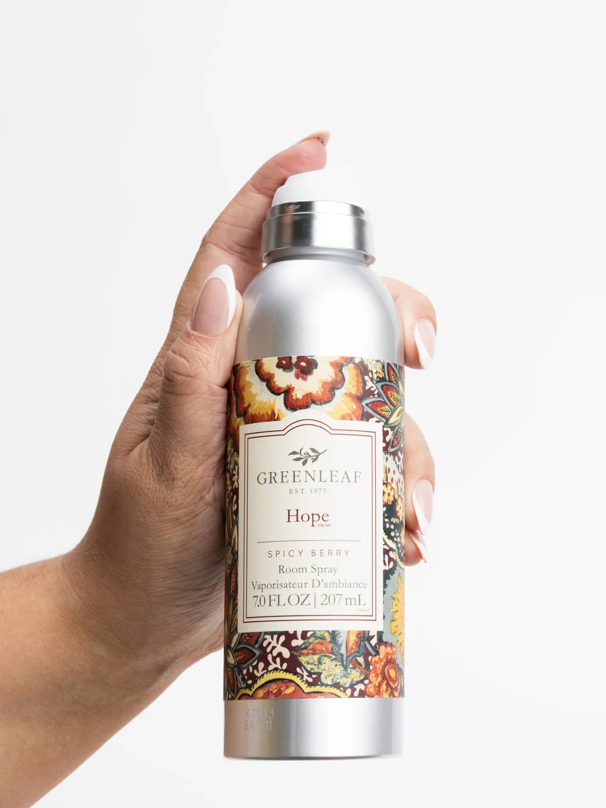 Hand holding Hope Room Spray Air Freshener with fruit and spice fragrance.
