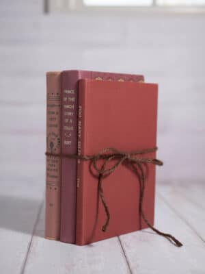 Decorative Vintage Book Set – Valentine’s with vintage hardback book spines in pink and red shades, tied with string