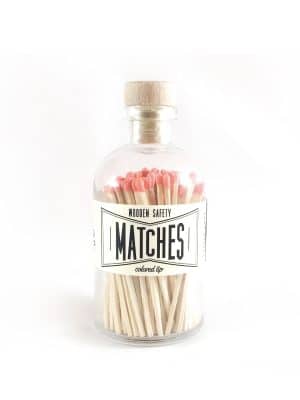 Vintage Apothecary Coral Matches in a glass jar with a wooden cork top and vintage-style label, showcasing vibrant coral-colored match tips.