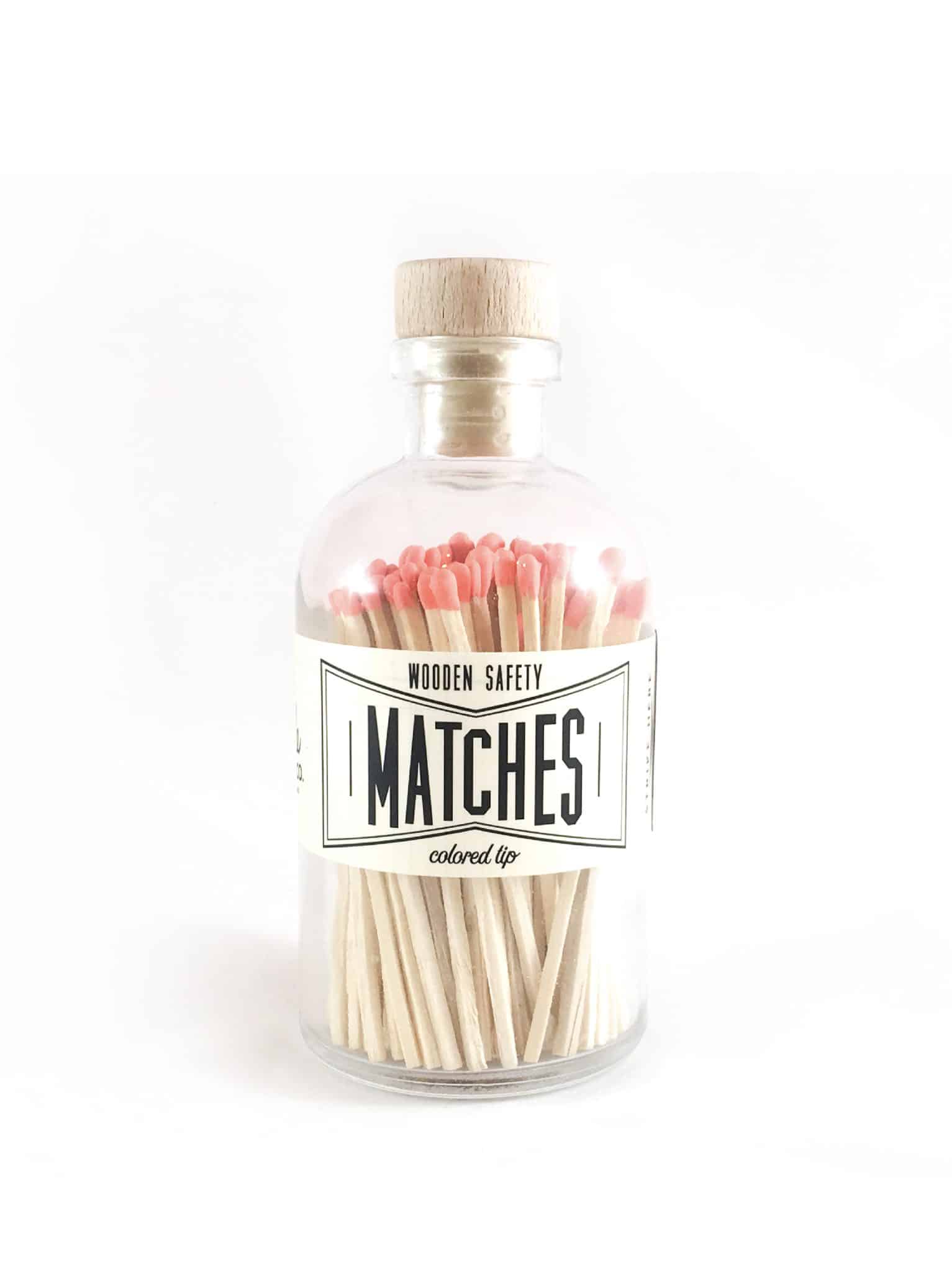Vintage Apothecary Coral Matches in a glass jar with a wooden cork top and vintage-style label, showcasing vibrant coral-colored match tips.