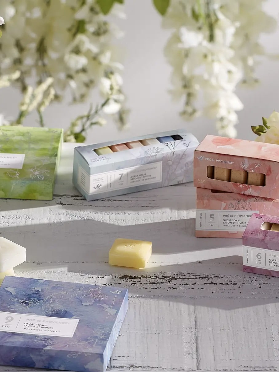 Assorted mini soap bar sets styled on a table with floral decor