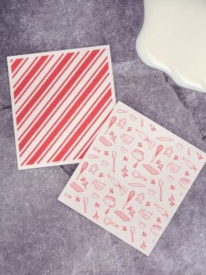 Swedish dishcloth with red holiday baking utensil and cookie illustrations.