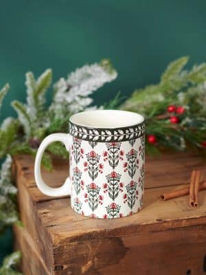 Floral block print mug styled with holiday greenery and rustic décor.