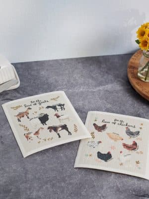 Two-pack of reusable dishcloths with farmhouse goat and chicken illustrations.