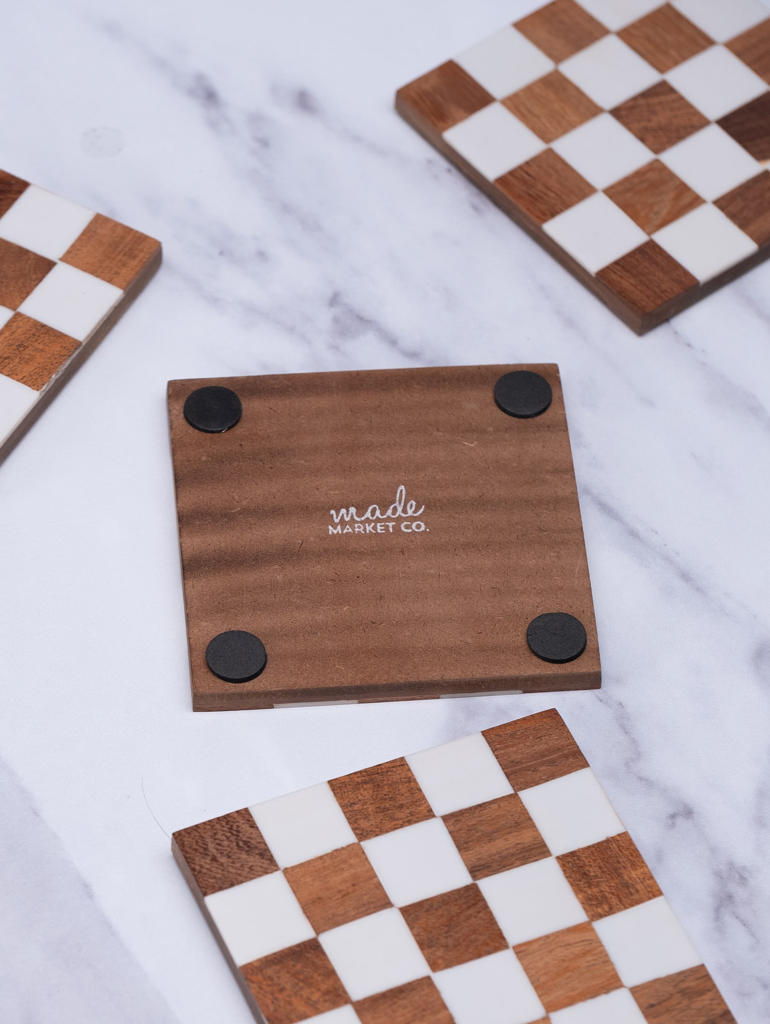 Checkered Wood Coasters with Stand spread on counter one upside down