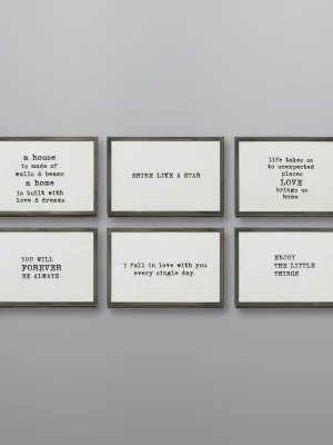 Set of six gunmetal easel frames with printed sentimental quotes displayed on a gray wall