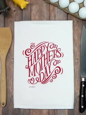 Off-white cotton tea towel with magenta “Happy Mother’s Day” lettering, styled on a wooden surface with kitchen tools.