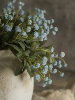 Blue Mini Star Bundle with petite blue blooms arranged in a stone vase for natural decor.