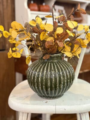 Ribbed Green Aged Terracotta Vase with mustard yellow eucalyptus and Brown Fall Leaf Sprays.