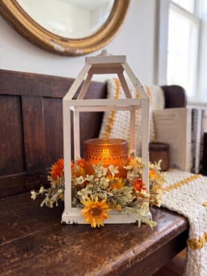Fall Welcome Styled Look with white lantern, orange flameless candle and fall candle ring