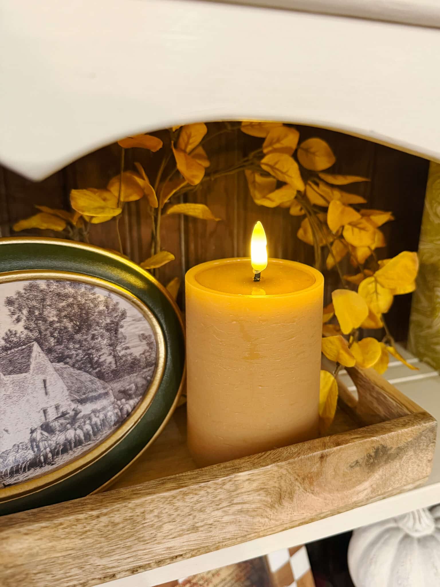 Light Yellow Eucalyptus Candle Ring with tan flameless candle on wood tray